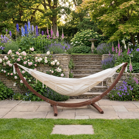 White double hammock on wooden stand in garden setting