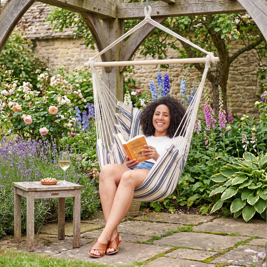 Blue striped hanging chair with cushions in garden