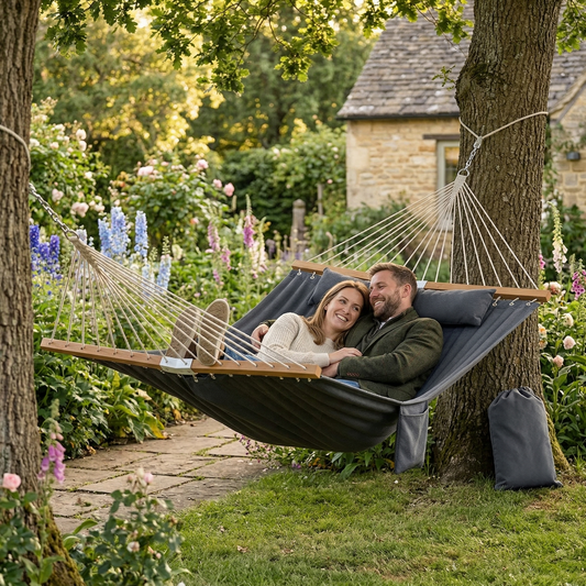 Quilted grey hammock hanging in a garden setting